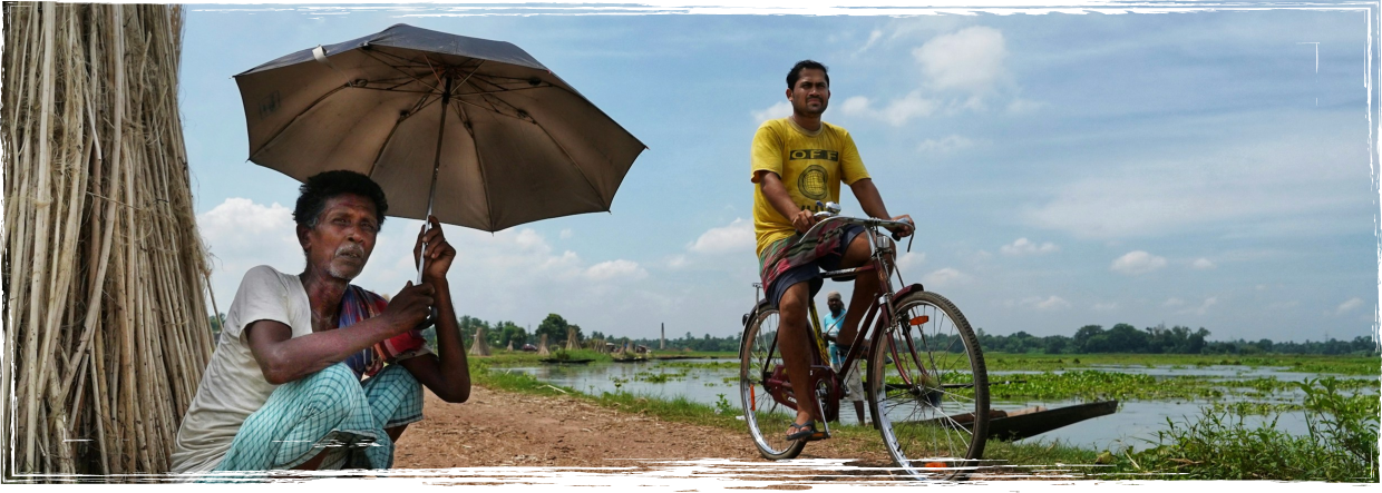 Vrutti story - people with umbrella and cyclist